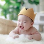 baby smiling in cap